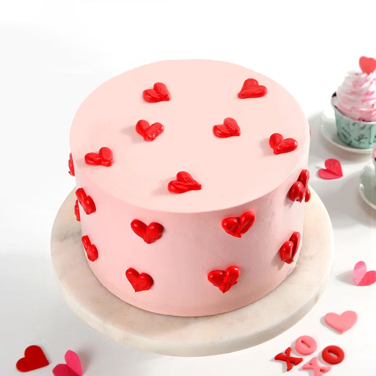 Pink heart love cake with red heart decoration for romantic cake delivery India