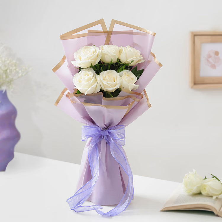 Fresh white roses bouquet in lavender wrapping for birthday anniversary and elegant gift