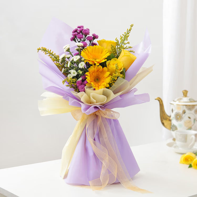 Yellow roses and gerberas mixed bouquet with purple flowers in lavender wrapping