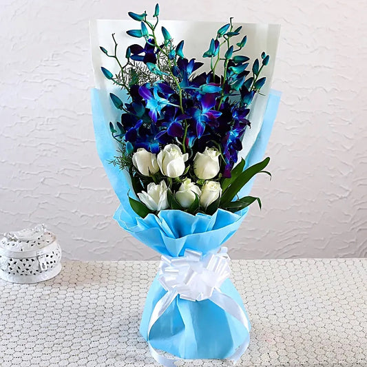 Blue orchid and white rose bouquet in premium blue wrapping with white ribbon