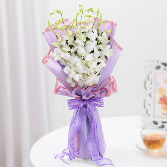 White orchid bouquet in lavender wrapping for same day flowe